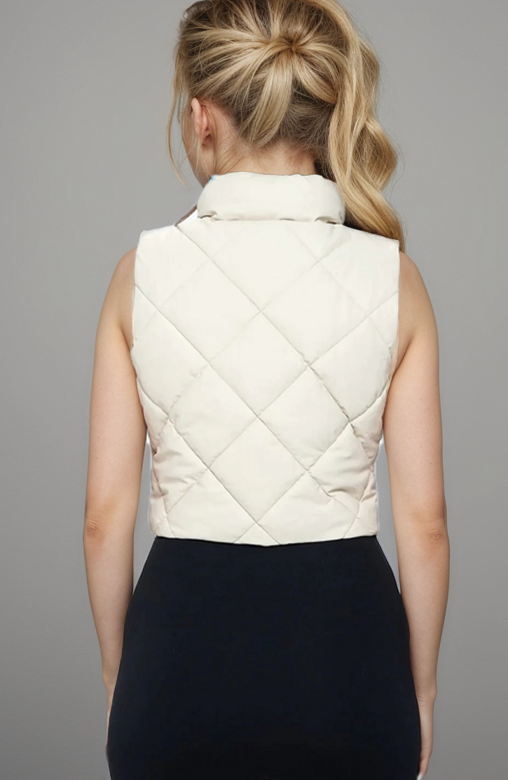 Fitkitty Culture vegan leather puffer vest for women, stylish and lightweight, featuring a quilted design in carbon color.