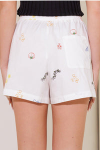 Flying Tomato After Hours white woven shorts, casual pants with a relaxed fit, displayed on a hanger.