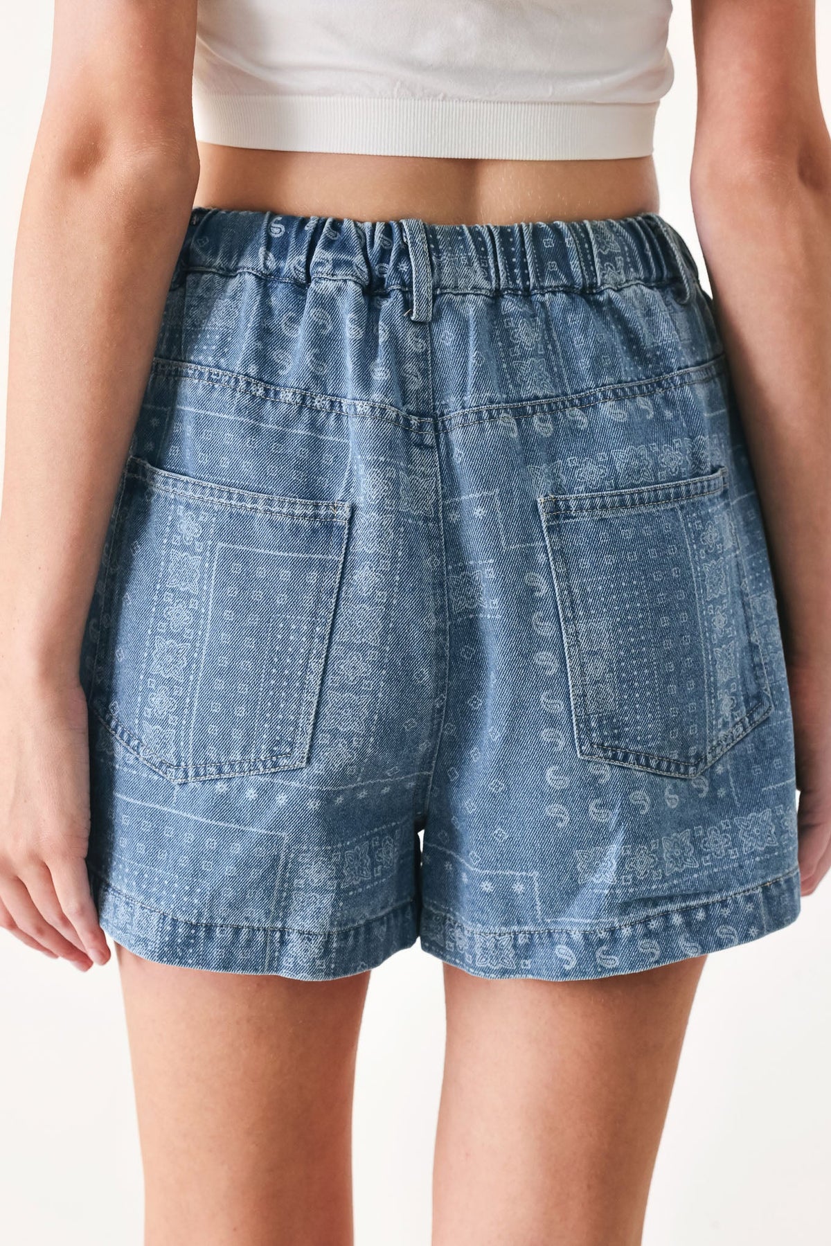 Light indigo vintage bandana denim shorts by Flying Tomato with distressed details and rolled hem.