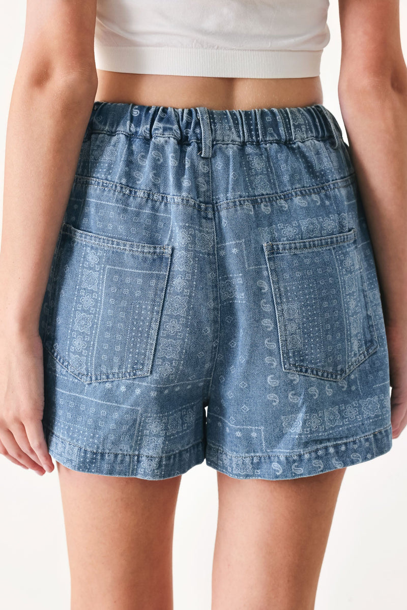 Light indigo vintage bandana denim shorts by Flying Tomato with distressed details and rolled hem.