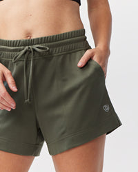 Dark moss green Goal Five G5 Advance 4.5-inch knit shorts shown with a close-up of the fabric and relaxed fit.