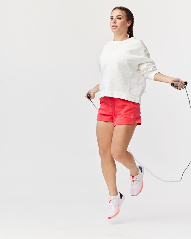 Goal Five G5 Advance 4.5-inch knit shorts in hot coral, showing the comfortable, stretchy fabric and casual fit.
