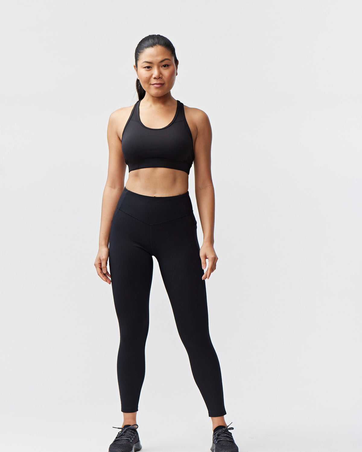 Black women's full-length leggings by Goal Five, designed for comfort and style, shown on a model.