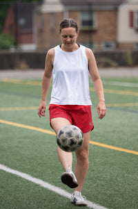 Goal Five boxy crop tank top styled with casual wear, featuring a relaxed fit and sleeveless design in a lifestyle setting.