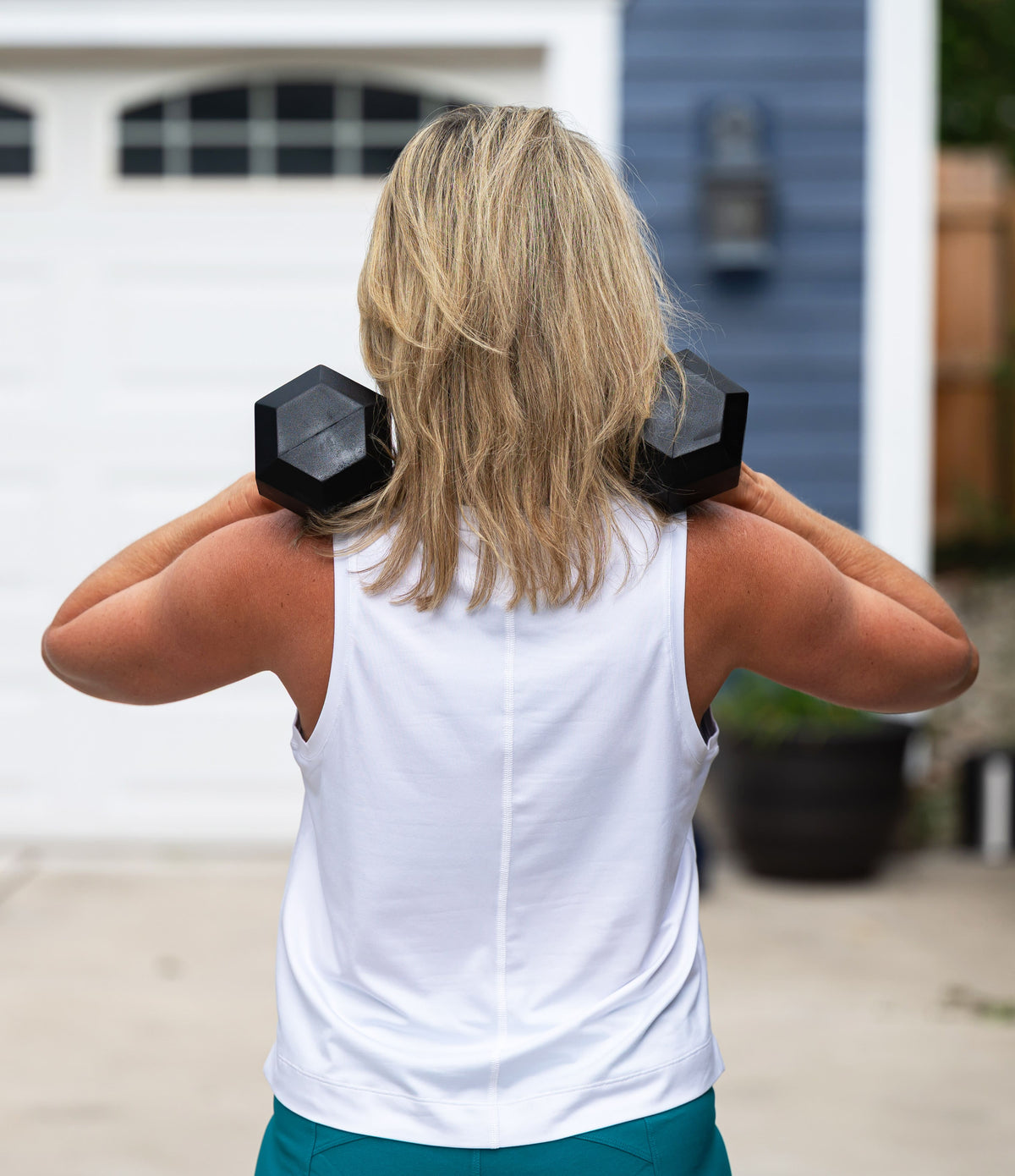 Goal Five boxy crop tank top, featuring a loose fit and sleeveless design, displayed on a model in a casual setting.