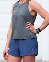 Goal Five boxy crop tank top displayed on a model, showcasing its relaxed fit and stylish design.