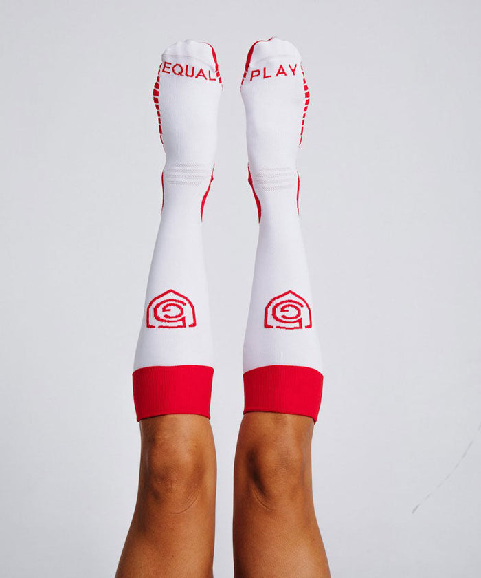 Equal Play women's soccer over-the-calf training socks by Goal Five in hot coral, designed for comfort and performance.