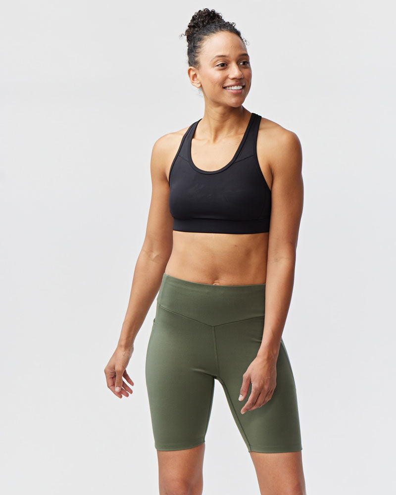 Dark moss Goal Five Go Again Bike Short 8" for training, featuring a close-up of the athletic fabric and fit.