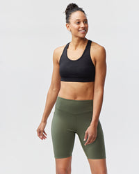 Dark moss Goal Five Go Again Bike Short 8" for training, featuring a close-up of the athletic fabric and fit.