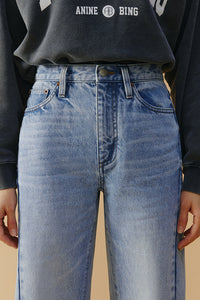 Hey Joanie High-Line Curve Ankle Jeans HJ016 with fitted silhouette and classic denim wash, displayed on a hanger.