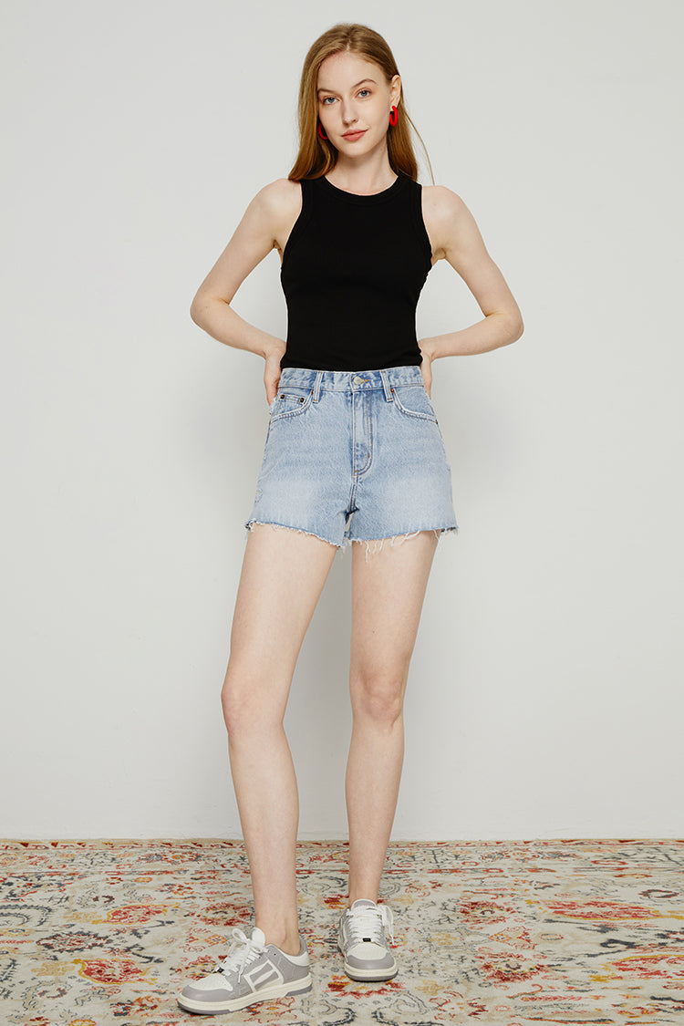 High rise denim shorts by Hey Joanie with a classic blue wash and frayed hem, styled for casual summer wear.
