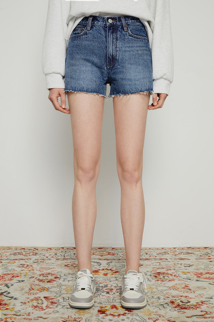 Hey Joanie high-rise denim shorts in light wash, front view showing distressed details and classic five-pocket design.