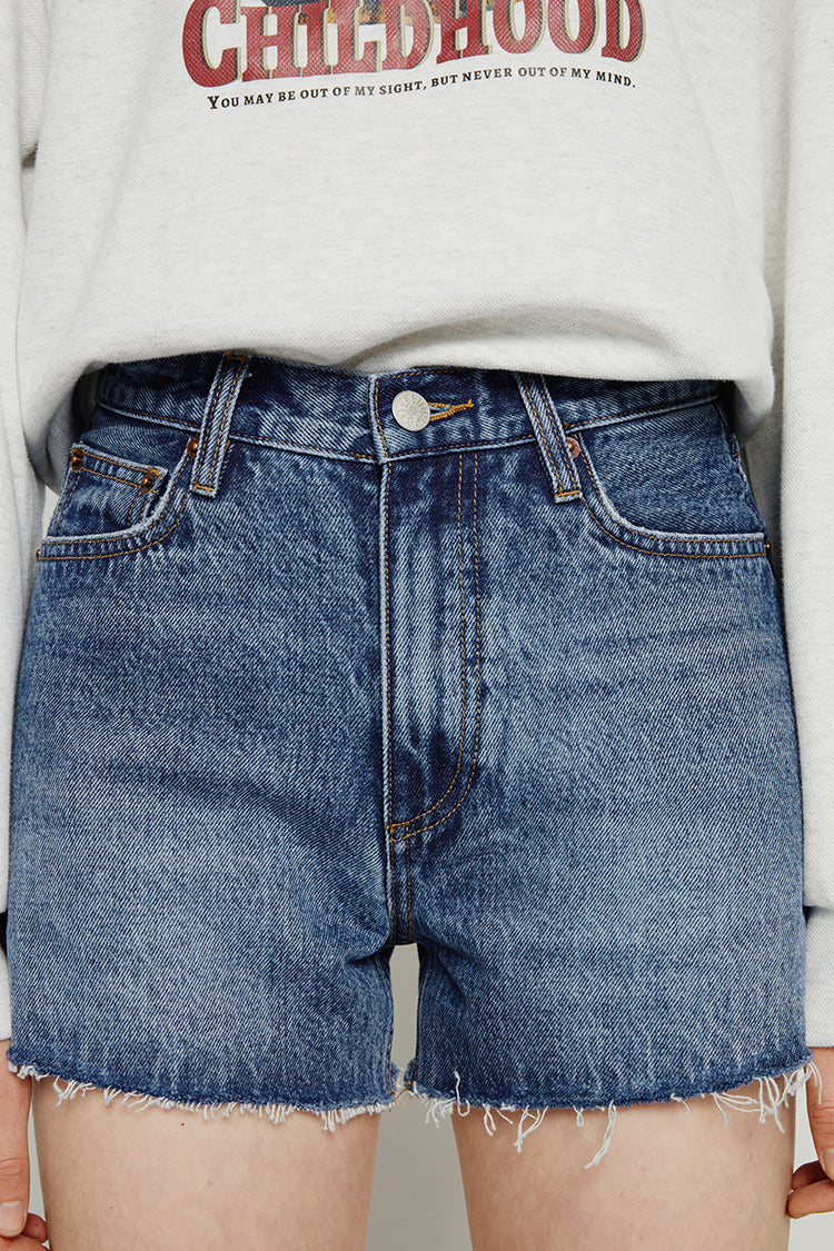 High rise denim shorts by Hey Joanie with a distressed finish and frayed hem, styled on a model for a casual summer look.