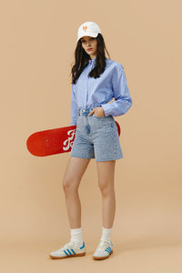 Hey Joanie Venice Tweed High Rise Shorts in beige, showcasing their textured fabric and stylish fit for a casual look.