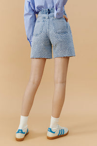 Hey Joanie Venice Tweed High Rise Shorts in beige, styled with a high waist and tailored fit for a chic summer look.
