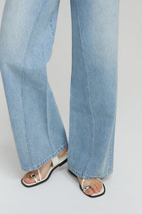 Hey Joanie Angeles High Rise Baggy Jeans with distressed details, worn by a model, showcasing relaxed fit and classic denim style.