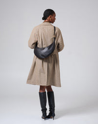 Black and gold The Ring Bag hobo bag by HYER GOODS featuring a distinctive ring detail and adjustable shoulder strap.