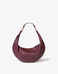 HYER GOODS The Ring Bag hobo bag in burgundy with a short strap, showing the front view and stylish design.