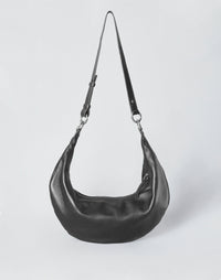 HYER GOODS black leather hobo bag with silver ring detail, stylish and spacious tote for everyday use.