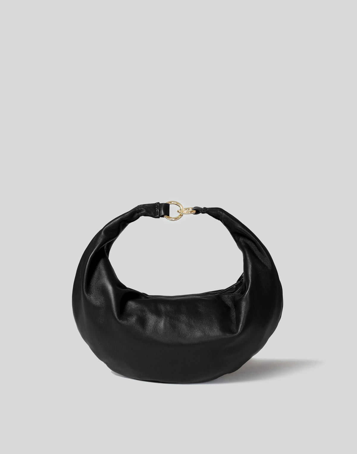 Black and gold hobo bag from HYER GOODS featuring a distinctive ring detail and a sleek front view