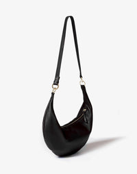 Black and gold hobo bag with a circular ring detail, stylish crossbody design by HYER GOODS.