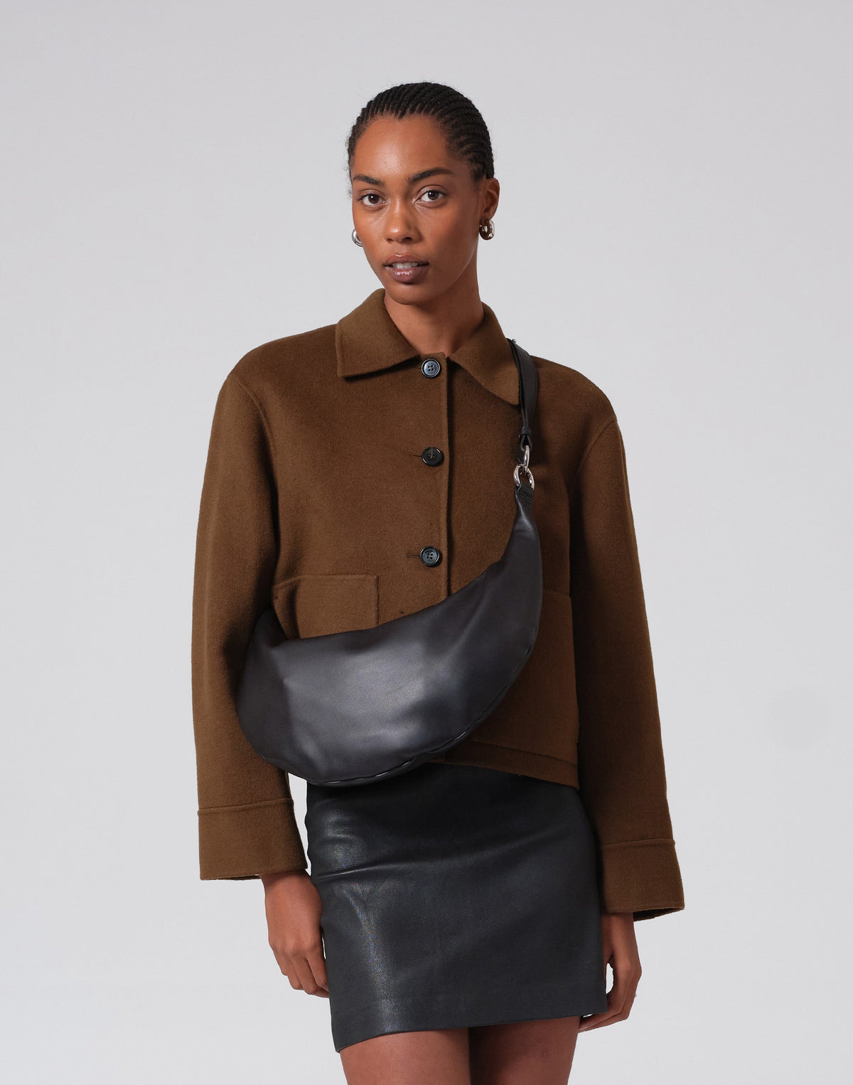 Black and silver hobo bag with a circular ring handle from HYER GOODS' The Ring Bag collection.