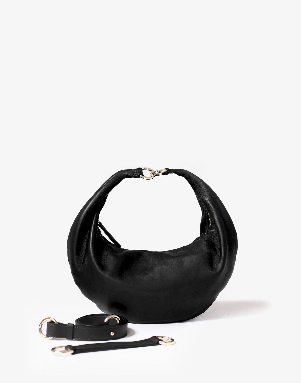 Black leather hobo bag with gold ring detail and shoulder straps, HYER GOODS Ring Bag styled for everyday use.