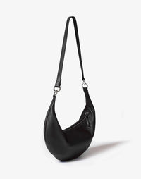 Black and silver HYER GOODS Ring Bag hobo crossbody bag with circular ring detail and adjustable strap.