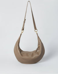 Hyer Goods Ring Bag hobo bag in taupe leather with a circular handle and minimalist design.