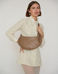 Taupe HYER GOODS Ring Bag hobo bag with circular handle and soft leather texture, stylishly displayed on a neutral background.