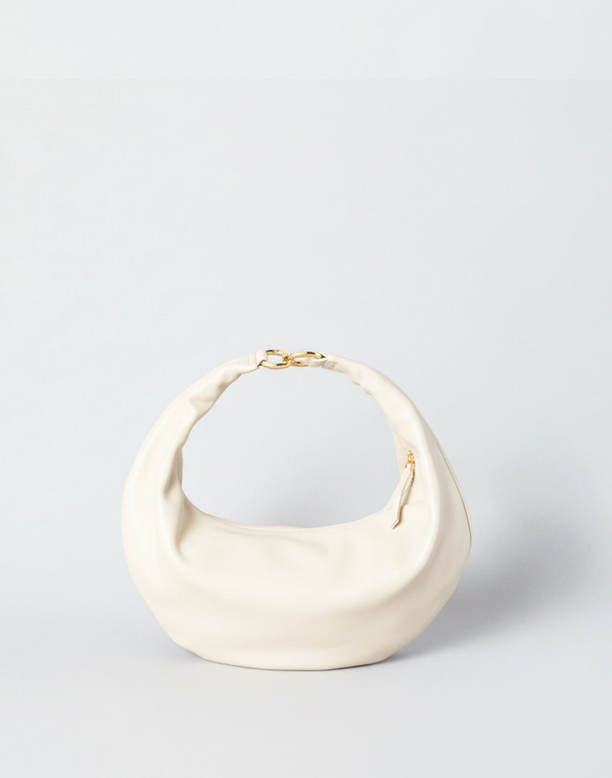 Off-white HYER GOODS Ring Bag hobo bag with circular handle and soft leather texture, styled as a versatile everyday accessory.