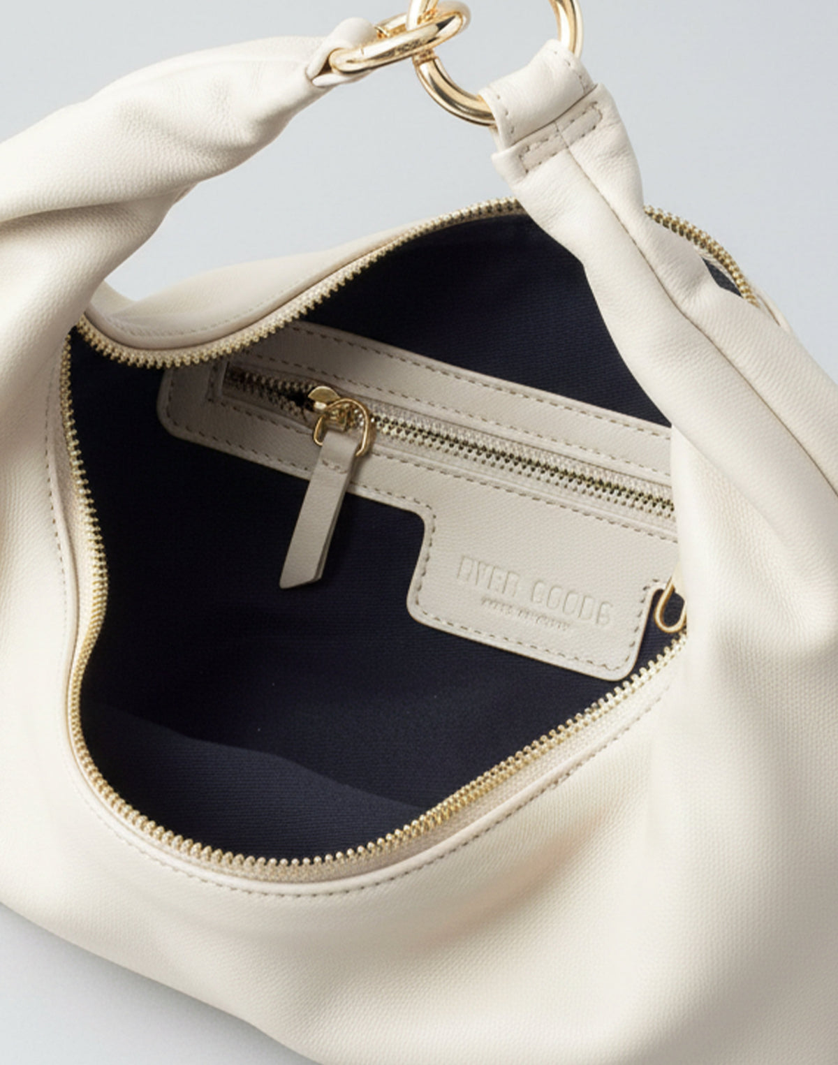 HYER GOODS Ring Bag hobo bag in off-white with interior view, showcasing its spacious design and minimalist style.