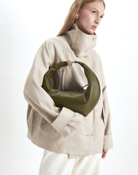 Olive-colored Hobo Bag by HYER GOODS featuring a circular ring design and soft leather texture.