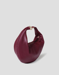 HYER GOODS Ring Bag hobo bag in Bordeaux leather with a prominent circular ring detail and adjustable strap.