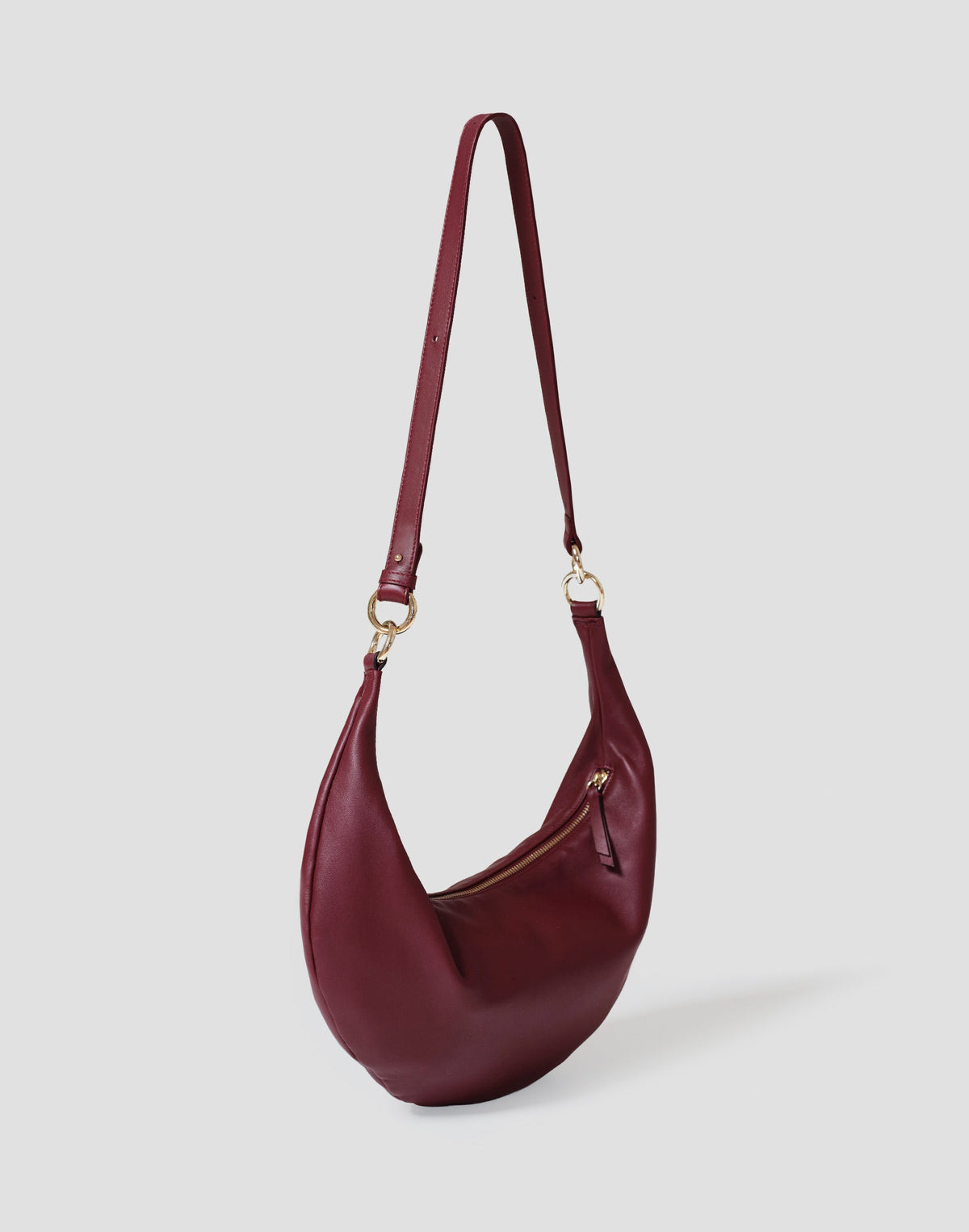 HYER GOODS The Ring Bag hobo crossbody bag in Bordeaux leather with rounded shape and adjustable strap.