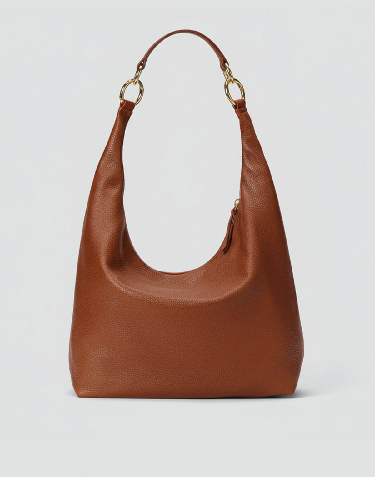 HYER GOODS Hobo Ring Bag in Cognac leather with adjustable strap and circular ring detail, casual and stylish for everyday use.