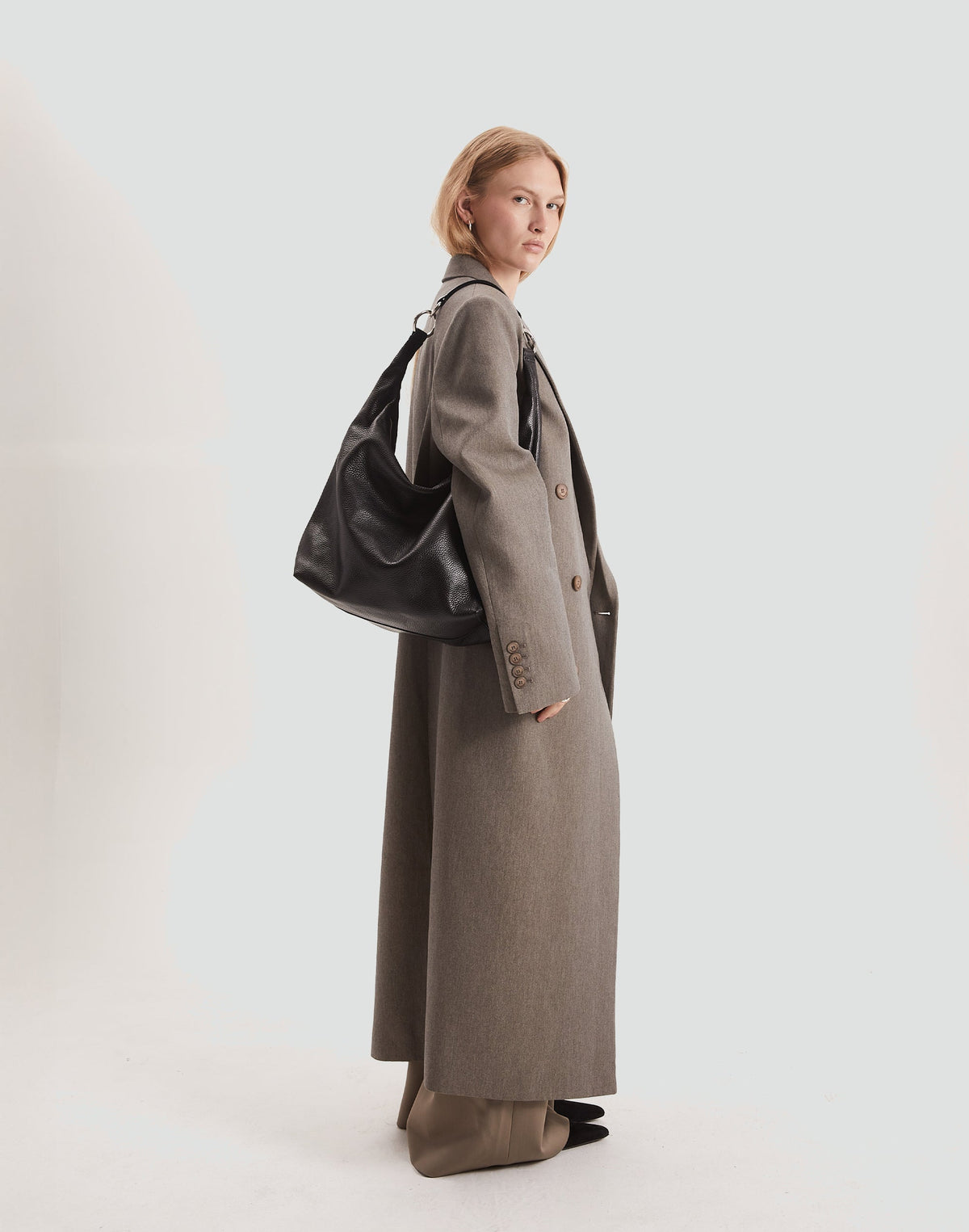 HYER GOODS Hobo Ring Bag in black with silver accents, stylish hobo bag featuring a unique ring handle and spacious interior.