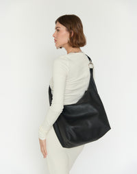 HYER GOODS Hobo Ring Bag in black with silver accents, styled as a versatile crossbody bag with a sleek, modern design.