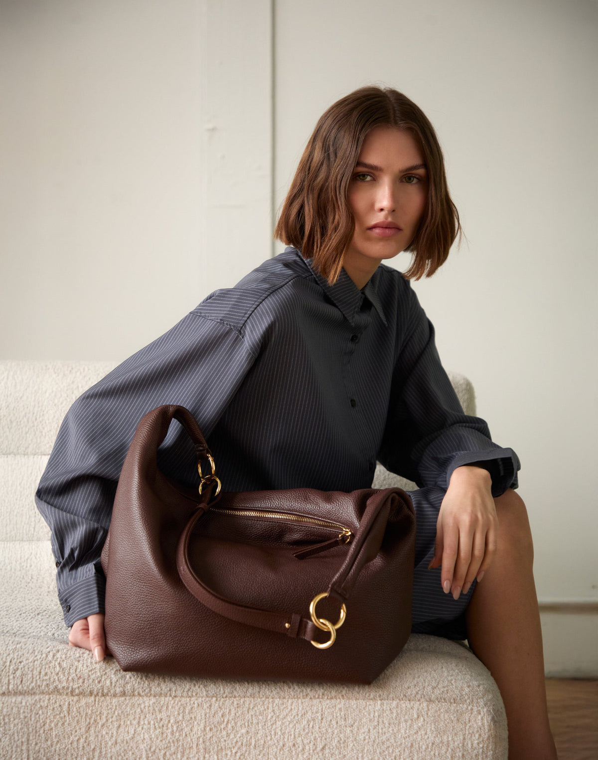 Brown HYER GOODS Hobo Ring Bag with rounded shape and adjustable strap, featuring a sleek, minimalist design.