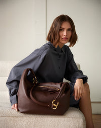 Brown HYER GOODS Hobo Ring Bag with rounded shape and adjustable strap, featuring a sleek, minimalist design.