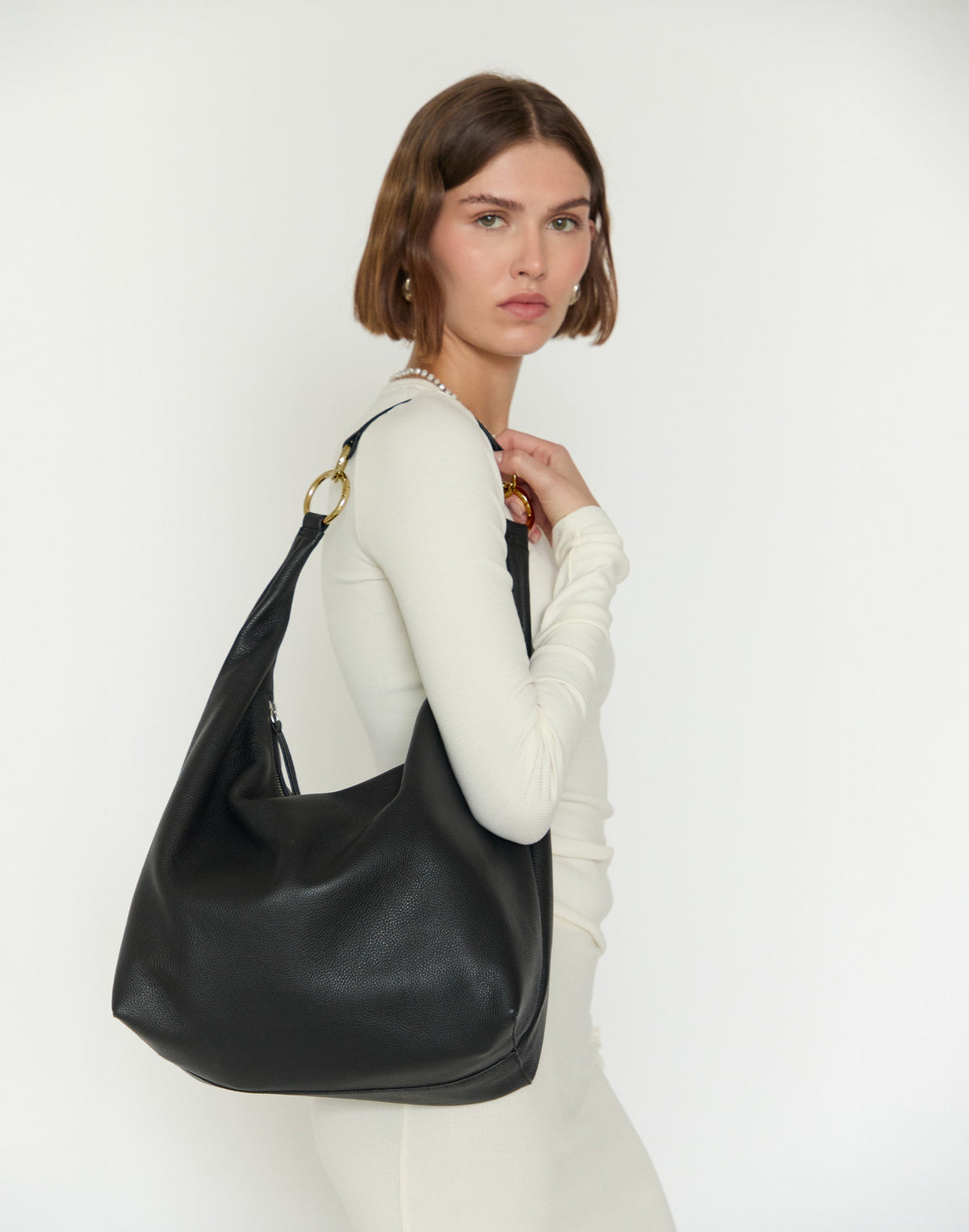 Black and gold HYER GOODS Hobo Ring Bag with rounded shape and shoulder strap, stylish and versatile for everyday use.