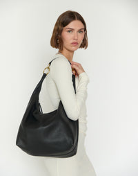 Black and gold HYER GOODS Hobo Ring Bag with rounded shape and shoulder strap, stylish and versatile for everyday use.