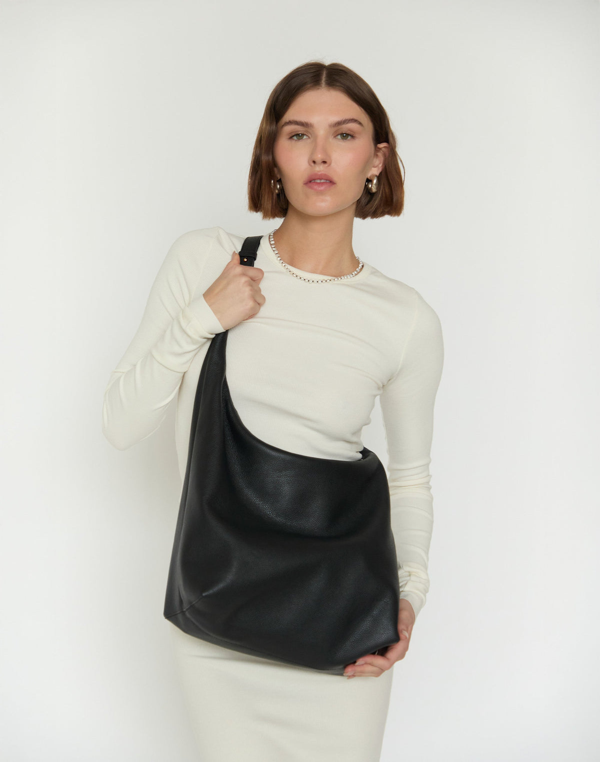 Black and gold HYER GOODS Hobo Ring Bag featuring a crossbody strap and stylish design.