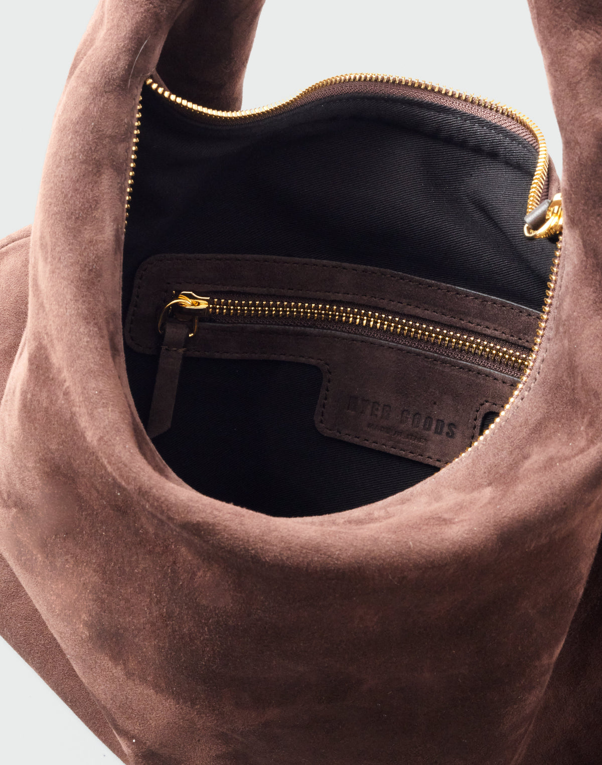 HYER GOODS hobo bag in chocolate suede with rounded shape and adjustable shoulder strap, stylish and functional accessory.