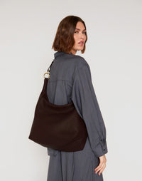 Dark chocolate Hobo Ring Bag by HYER GOODS featuring a stylish crossbody design with rounded shape and adjustable strap.