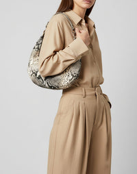 HYER GOODS Piccola Ring Bag hobo bag in python pattern with circular handle and compact design.