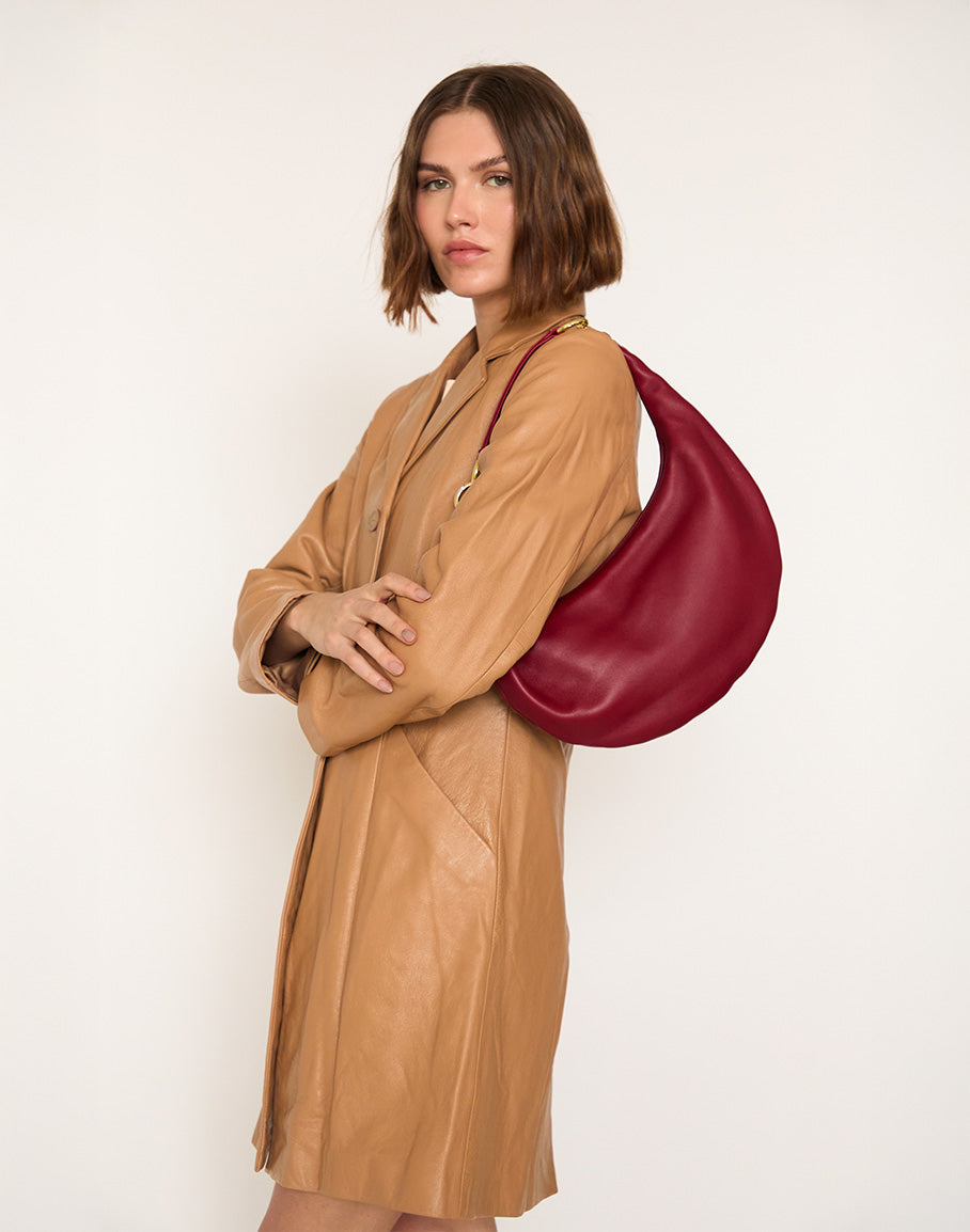 HYER GOODS Piccola Ring Bag in cherry red, a stylish hobo bag with a rounded shape and minimalist design.