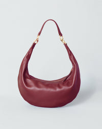 Red Piccola Ring Bag by HYER GOODS, a compact hobo bag with a sleek design and a distinctive ring detail.