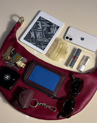 Red HYER GOODS Piccola Ring Bag, a stylish hobo bag with a unique ring detail, shown with its interior and compact design.