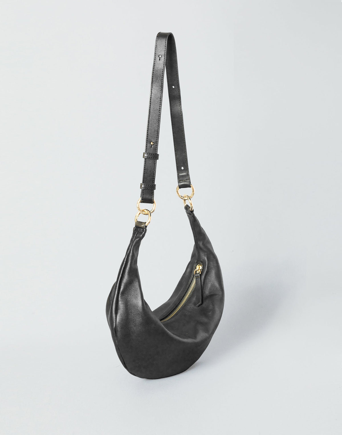 HYER GOODS Piccola Ring Bag hobo bag in black with gold accents, featuring a compact design and circular handle for stylish carrying.